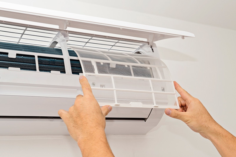 man fixing ductless unit