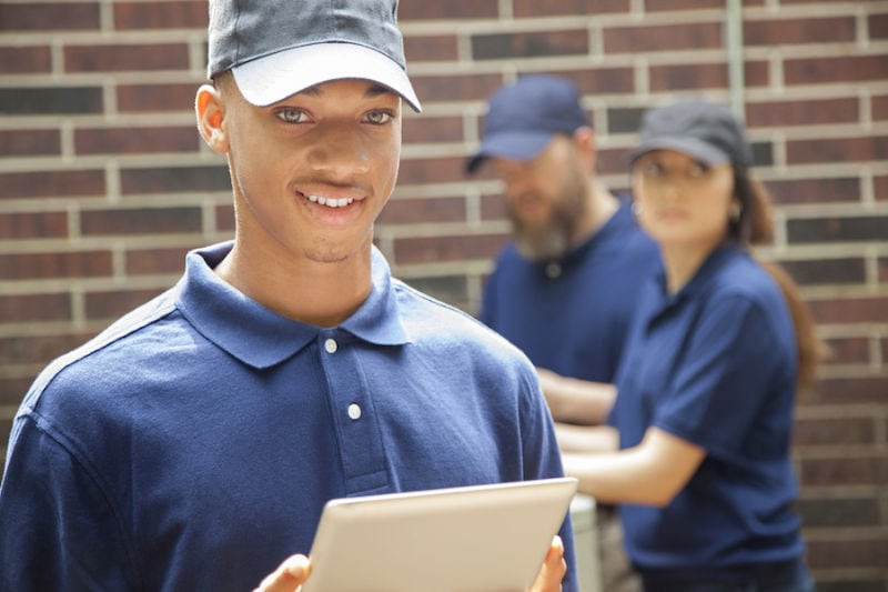 Air conditioner repairmen work on home unit. Blue collar workers. Air conditioner repairmen work on home unit. Blue collar workers.