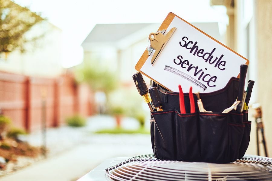 Image of HVAC unit with service sign on it. What Does an HVAC Maintenance Inspection Include?