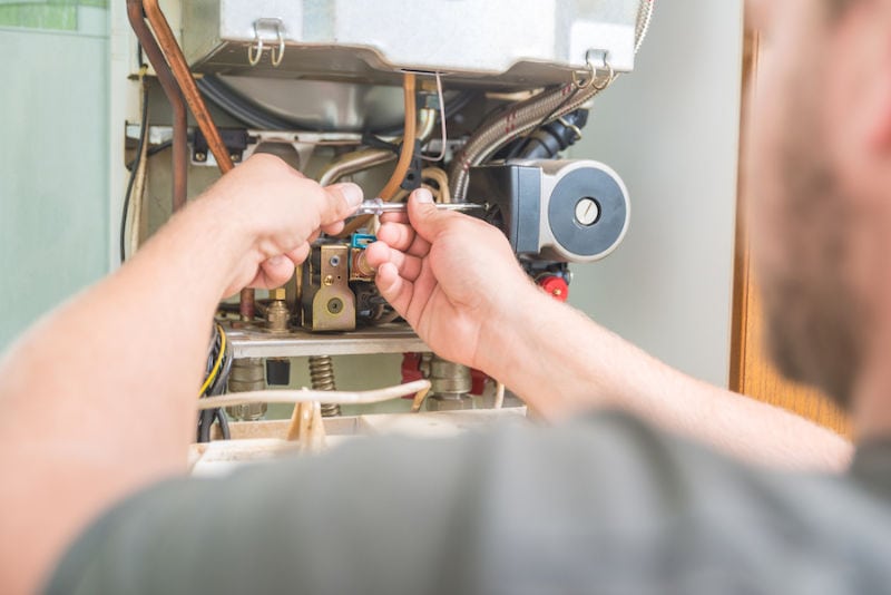 Technician repairing Gas Furnace